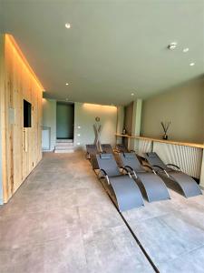 Albergo Rutzer في أسياجو: غرفة كبيرة مع صفوف من الكراسي في غرفة