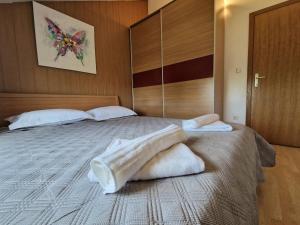 a bedroom with a bed with towels on it at Promenada Apartment in Srima