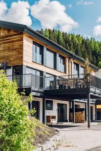 a modern house with a balcony and trees at Chalet W - auf der Planai -zu jeder Jahreszeit in Schladming