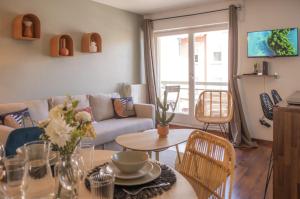 a living room with a couch and a table at L'Eldorado - Tout confort in Strasbourg