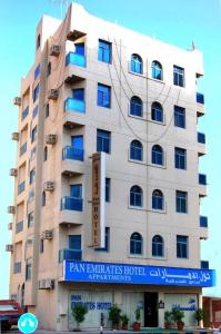 a large building with a sign in front of it at PAN EMIRATES HOTEL APARTMENTS in Sharjah
