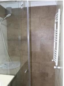 a shower with a glass door in a bathroom at Apartment in Batumi in Batumi