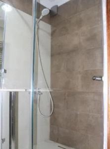 a shower with a shower head in a bathroom at Apartment in Batumi in Batumi