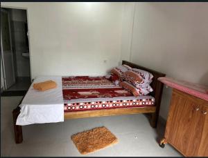 a small bedroom with a bed in a room at Kandy Holiday Home in Kandy