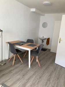 a dining room table with two chairs and a table at Quins in Aalen