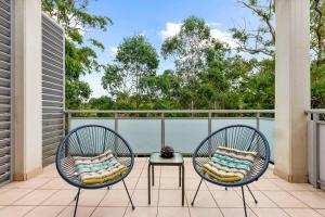 two chairs and a table on a balcony at cosy Chatswood retreat, conventience location in Sydney