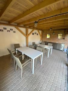 un grupo de mesas y sillas en una habitación en Noclegi Mazurow, en Malbork