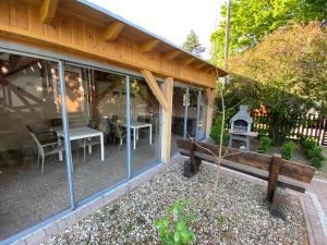 a screened in porch with a bench and a grill at Noclegi Mazurow in Malbork