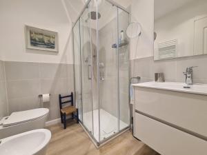 a bathroom with a shower and a toilet and a sink at Ginger by PortofinoVacanze in Rapallo