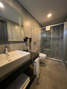 a bathroom with a sink and a shower and a toilet at Falcon 1511 in Antalya