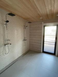 a large bathroom with a shower and a window at Peipsi Villad in Kuru