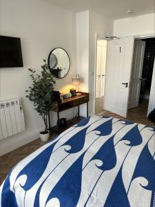 a bedroom with a bed and a table and a mirror at The Lugger Inn in Polruan