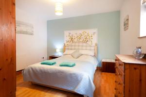 a bedroom with a bed with two pillows on it at Garden cottage in South Collingham