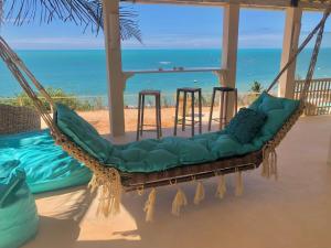 a hammock on the beach with a view of the ocean at Casa Mar & Céu in Redonda