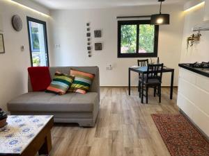 a living room with a couch and a table at חצר ברמה in Sha'al