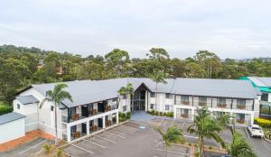an aerial view of a building with palm trees at Warners at the Bay in Warners Bay