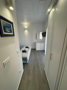 a hallway of a room with a bed and a refrigerator at Apartments Stone Tučepi in Tučepi