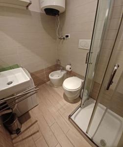 a bathroom with a toilet and a sink and a shower at Casa di Gabriella in Grado