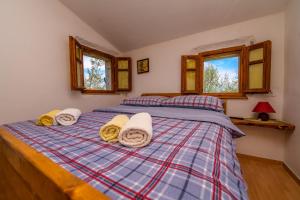 a bedroom with a bed with towels on it at Betlehem & Nazaret cottage on Krk island in Krk