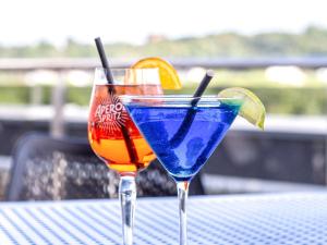 two cocktails sitting on top of a table at IBIS Styles Kaunas Centre in Kaunas
