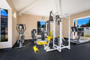 a gym with treadmills and elliptical machines at SureStay Plus Hotel by Best Western Upland - Ontario North in Upland