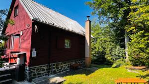 a red barn with a red roof at Chata Jedovnice in Jedovnice