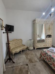 a living room with a chair and a dresser at Villa Torricelli Scarperia - Il Giardinetto Residence in Scarperia