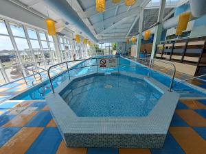 a large swimming pool in a building at Withernsea luxury caravan hire in Waxholme