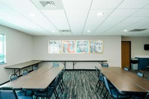 a classroom with tables and chairs in a room at AmericInn by Wyndham Tomahawk in Tomahawk