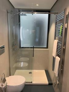 a bathroom with a shower and a toilet and a sink at Donna Caterina in Monopoli