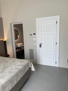 a bedroom with a bed and a white door at Donna Caterina in Monopoli