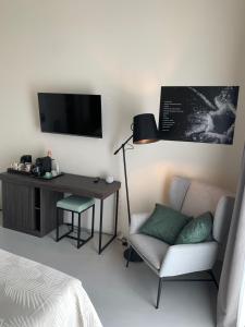 a living room with a couch and a desk and a television at Donna Caterina in Monopoli