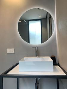 a bathroom with a white sink and a mirror at Donna Caterina in Monopoli