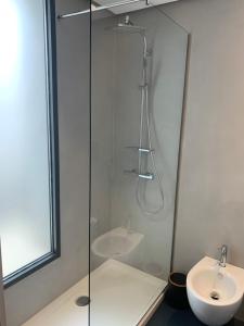 a bathroom with a glass shower and a sink at Donna Caterina in Monopoli