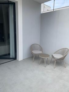 two chairs and a table in a room at Donna Caterina in Monopoli