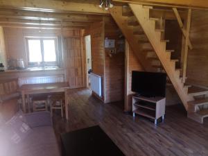 an overhead view of a living room with a staircase and a television at DOMKI CZYRNA SZCZYRK in Szczyrk