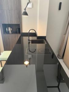 a small kitchen with a sink and a counter top at Donna Caterina in Monopoli