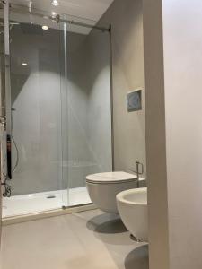 a bathroom with a shower and a toilet and a sink at Donna Caterina in Monopoli