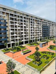 a large apartment building with a courtyard with trees at StayPoint Apartment in Podgorica