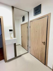 a bathroom with a sliding glass door and a sink at StayPoint Apartment in Podgorica