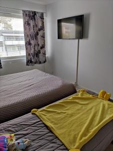 a bedroom with a bed with a yellow blanket at Kempele city center in Kempele