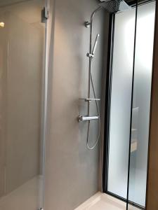 a shower with a glass door in a bathroom at Donna Caterina in Monopoli