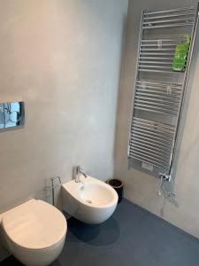 a bathroom with a white toilet and a sink at Donna Caterina in Monopoli