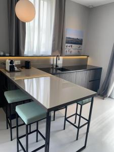 a kitchen with a table and two stools at Donna Caterina in Monopoli