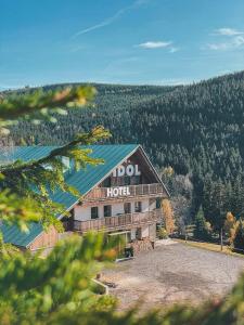 a hotel with a sign on the side of a building at Horský Hotel Idol in Horni Misecky