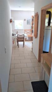 a hallway with a kitchen with a table and a refrigerator at Highland Accommodation Bavaria in Weilheim in Oberbayern