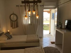 a bedroom with a bed and a mirror and a door at Francesca Secret in Mikonos