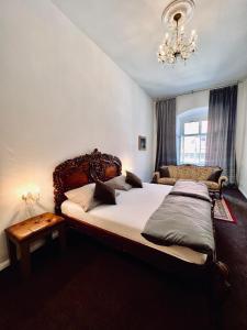a bedroom with two beds and a chandelier at Csaky Palace Bratislava in Bratislava