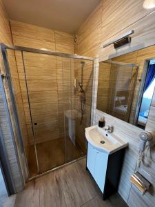 a bathroom with a shower and a sink at Villa Mors in Mielno