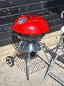 a grill with a red lid on top of it at The Old Workshop Oxford Countryside Apartment - Wifi - Free Parking in Oxford